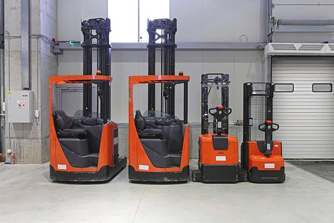 a row of industrial forklifts on a factory floor